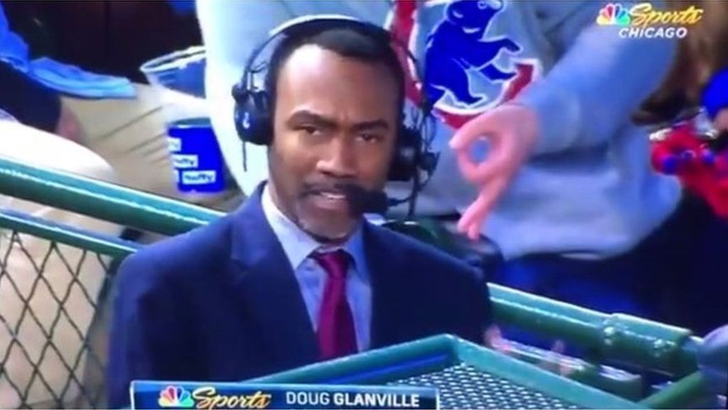 FANS FLASHES WHITE POWER SIGN DURING CUBS TELECAST