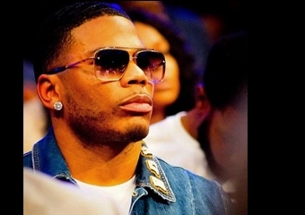 NELLY FALLS OFF STAGE WHEN FAN GRABS HIS ARM